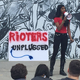 A Riot employee speaking to her colleagues through a megaphone